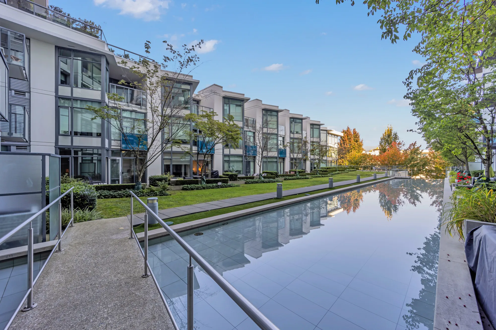 The courtyard: a long reflecting pool between lawns, the townhouse fronts of the building either side