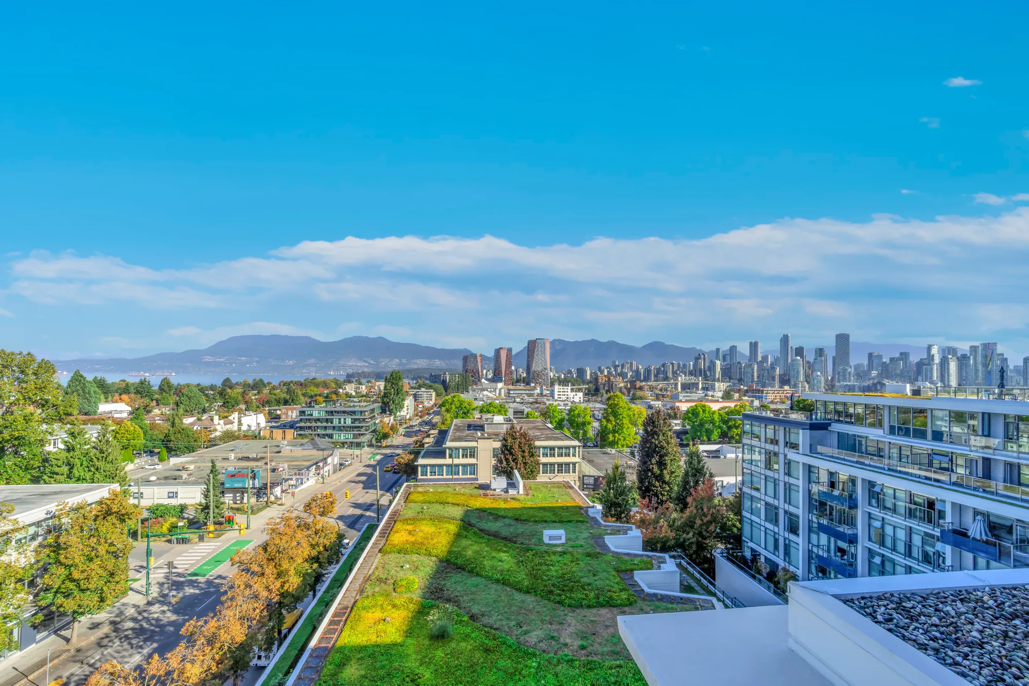 From the rooftop: the towers of downtown Vancouver and the mountains beyond